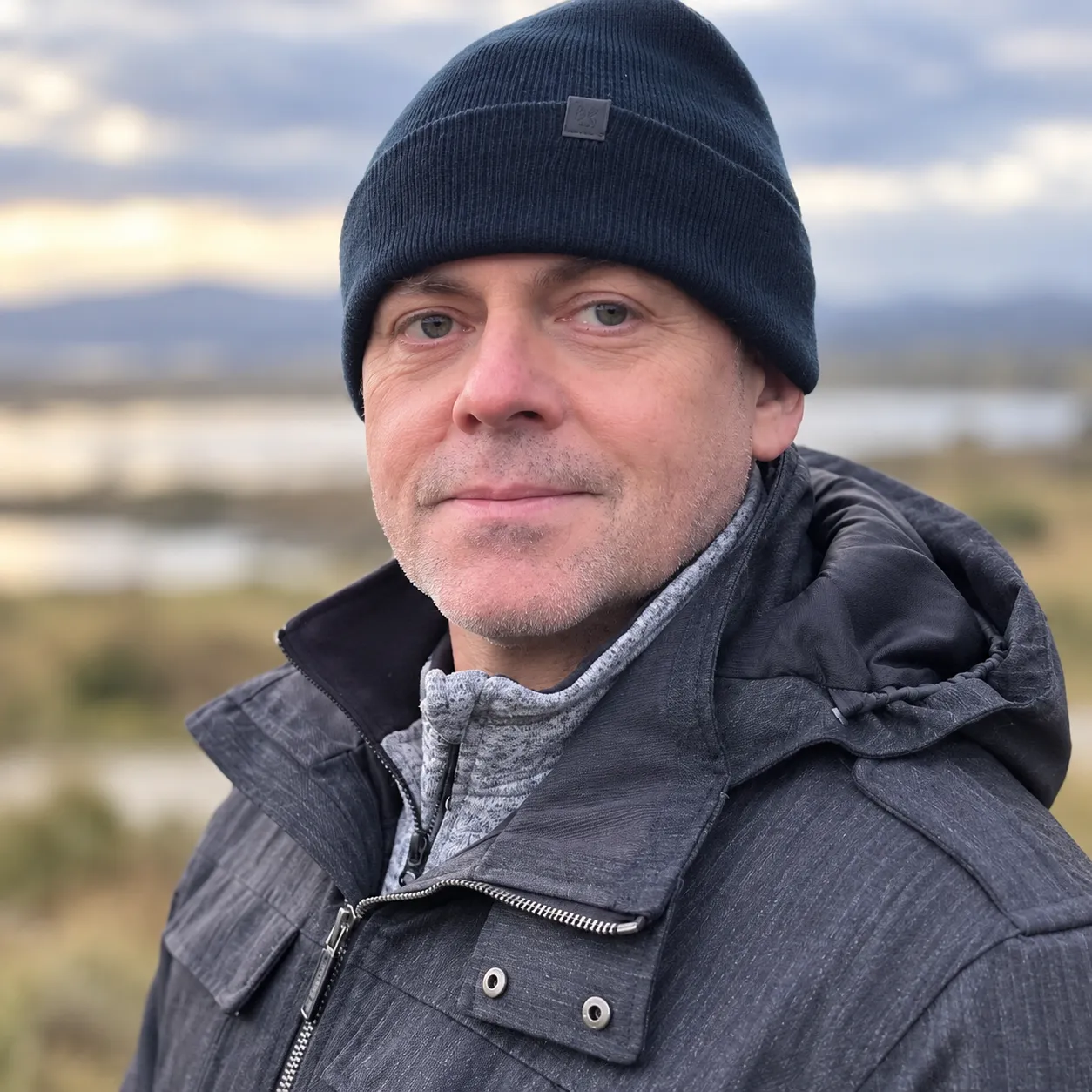 Chris, who builds the websites at Scotland Digital, outdoors in a beanie hat